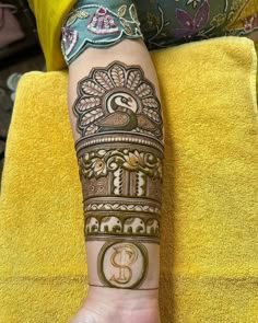 a woman's arm with henna tattoos on it