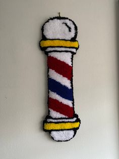 a toothbrush shaped like a cat toy hanging on the wall