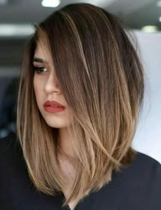 a woman with brown hair and red lipstick is looking off to the side while wearing a black shirt