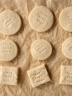 six crackers are arranged on wax paper