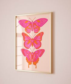 a pink butterfly print hangs on the wall