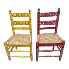 two chairs made out of wood with different colors and designs on the back one is red, the other is yellow