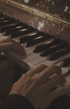 a person is playing the piano with their hands