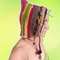 a woman wearing a crocheted hat with braids on her head and neck