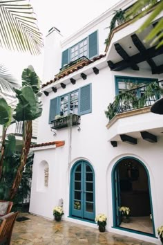 a white house with blue shutters and windows