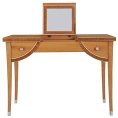 a small wooden desk with a mirror on it's top and drawers underneath the table