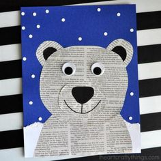 a polar bear made out of newspaper on a striped tablecloth with black and white stripes