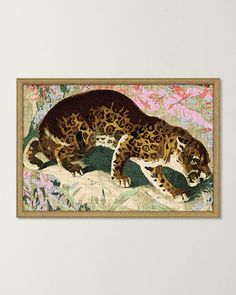 a framed painting of a leopard on a wall in a room with pink and green flowers