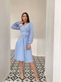 Step into the spotlight with our elegant Light Blue A-Line Midi Dress. Crafted in a semi-matte fabric, this autumn midi dress is your go-to for any formal occasion, from being the chicest guest to an autumn wedding to making heads turn at birthday parties. Its natural waistline and unmissable lantern sleeve give off a regal vibe while flattering every figure type. The back zipper ensures a snug fit that enhances your silhouette without compromising comfort. You'll love its adaptability! Wear it Dressy Fall Wedding Midi Dress, Chic Light Blue Midi Dress For Fall, Elegant Light Blue Fall Dress, Elegant Light Blue Midi Dress For Fall, Elegant Blue Dress For Fall, Blue Semi-formal Dress For Fall, Elegant Light Blue Midi Dress For Formal Occasions, Light Blue Midi Dress For Office, Blue Long Sleeve Midi Dress For Formal Occasions