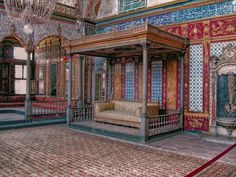 an elaborately decorated room with chandelier and couch