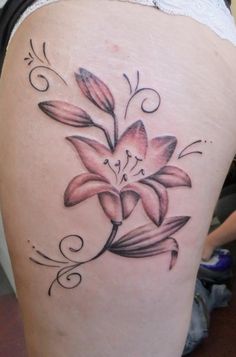 a woman's thigh with a flower tattoo on it