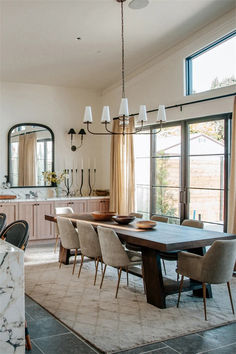 a dining room table with chairs and a chandelier