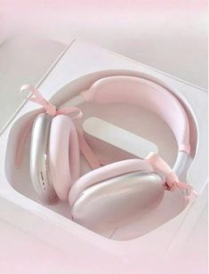 a pair of pink headphones in a white box