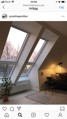 a room with three large windows and a couch in the corner next to a window