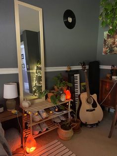 a living room filled with furniture and a guitar