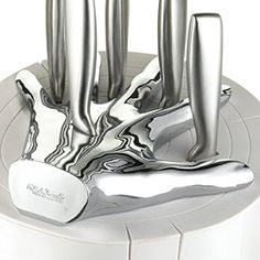 a knife holder with four knives on it's sides and one in the middle