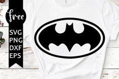 a batman svg cut file is shown on a white t - shirt with black lettering