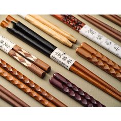 many different types of chopsticks lined up on a table