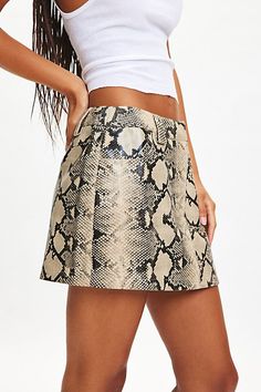 Standout By. Dyln mini skirt in a slim, pencil silhouette. Designed in a bold snake-print faux leather featuring a low-rise waistline that sits at the hips, belt lpps an side pockets. Features By. Dyln Xaavier snake print faux leather mini skirt Low rise mini skirt Snake print faux leather Low rise waistline with belt loops Side pockets Slim fit Mini length Zip fly and internal hook closure Content + Care 55% Polyester, 45% polyurethane Machine wash Imported Size + Fit Model in Snake Print is 5’9" and wearing size Small Measurements taken from size Small Length: 12" | By.Dyln Xaavier Snake Print Faux Leather Mini Skirt, Women's at Urban Outfitters Snakeskin Skirt, Low Rise Mini Skirt, Pencil Silhouette, Men's Shoes Accessories, Faux Leather Mini Skirt, Leather Mini Skirt, Women Men Shoes, Leather Mini Skirts, Leather Mini