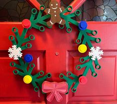 a christmas wreath made out of paper on a red door