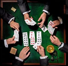 several people are playing cards on a table