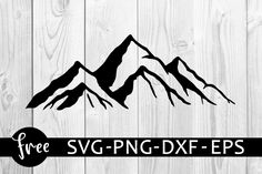 the mountain svg - png dxf eps file is shown on a wooden background