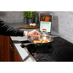 a person is cooking food in a pan on the stove top with an appliance