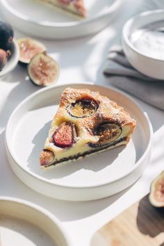 a slice of pie on a plate with figs around it