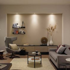 a living room with two couches and a coffee table in front of the wall