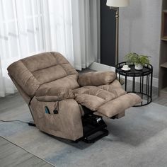 a living room with a reclining chair in it and a lamp on the side table