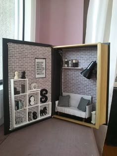 a dollhouse with a couch and shelves in it