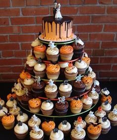 a wedding cake made out of cupcakes on a table