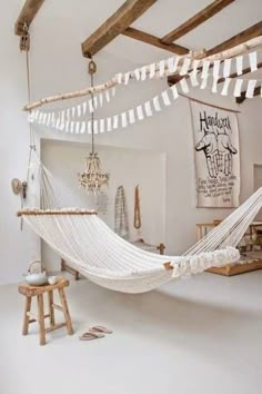 a white hammock hanging from the ceiling