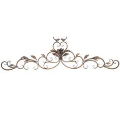 an ornate metal wall decoration with scrolls and flowers on the sides, set against a white background