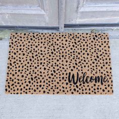 a welcome mat with the word welcome on it in front of an open door,