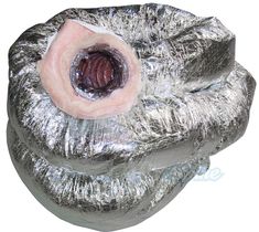 a close up of an object made out of aluminum foil with a large piece of meat in the center