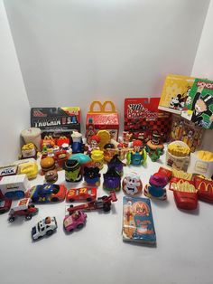 various toys and other items on a white surface, including mcdonald's lunch box