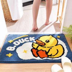 a bathroom rug with a rubber ducky on the front and feet next to it