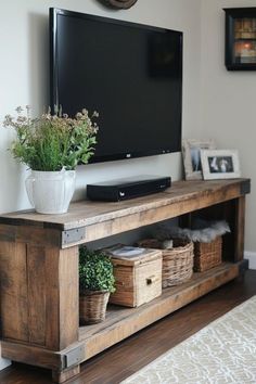 a flat screen tv sitting on top of a wooden entertainment center in a living room