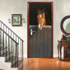 there is a horse peeking through the door to see what's in the room