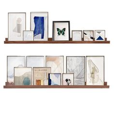 two wooden shelves filled with pictures and framed artwork