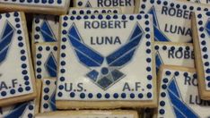 cookies decorated with blue and white icing are arranged in the shape of u s air force emblems