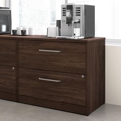 an espresso machine sitting on top of a wooden dresser