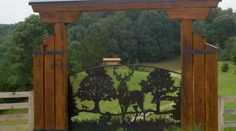 a wooden gate with a deer scene on it