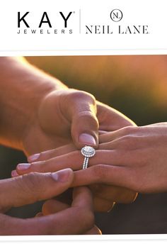 two people holding hands and touching each other with their wedding rings on top of them