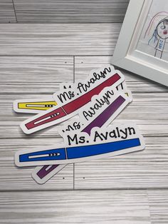 three magnets with the words miss hudson and ms alwaysn on them next to a framed photo