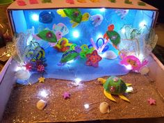 an aquarium filled with lots of different types of sea animals and fish in it's display case