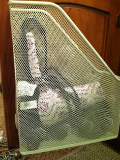 an ironing board with several pieces of fabric on it in front of a cabinet