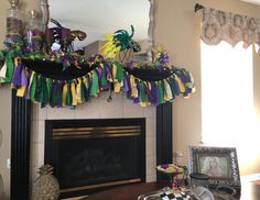 a living room decorated for mardi gras with decorations on the mantel and fireplace