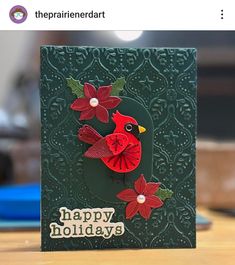 a close up of a card with a bird and poinsettis on it